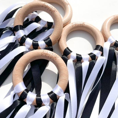 Wooden rings with black and white ribbons on a white background