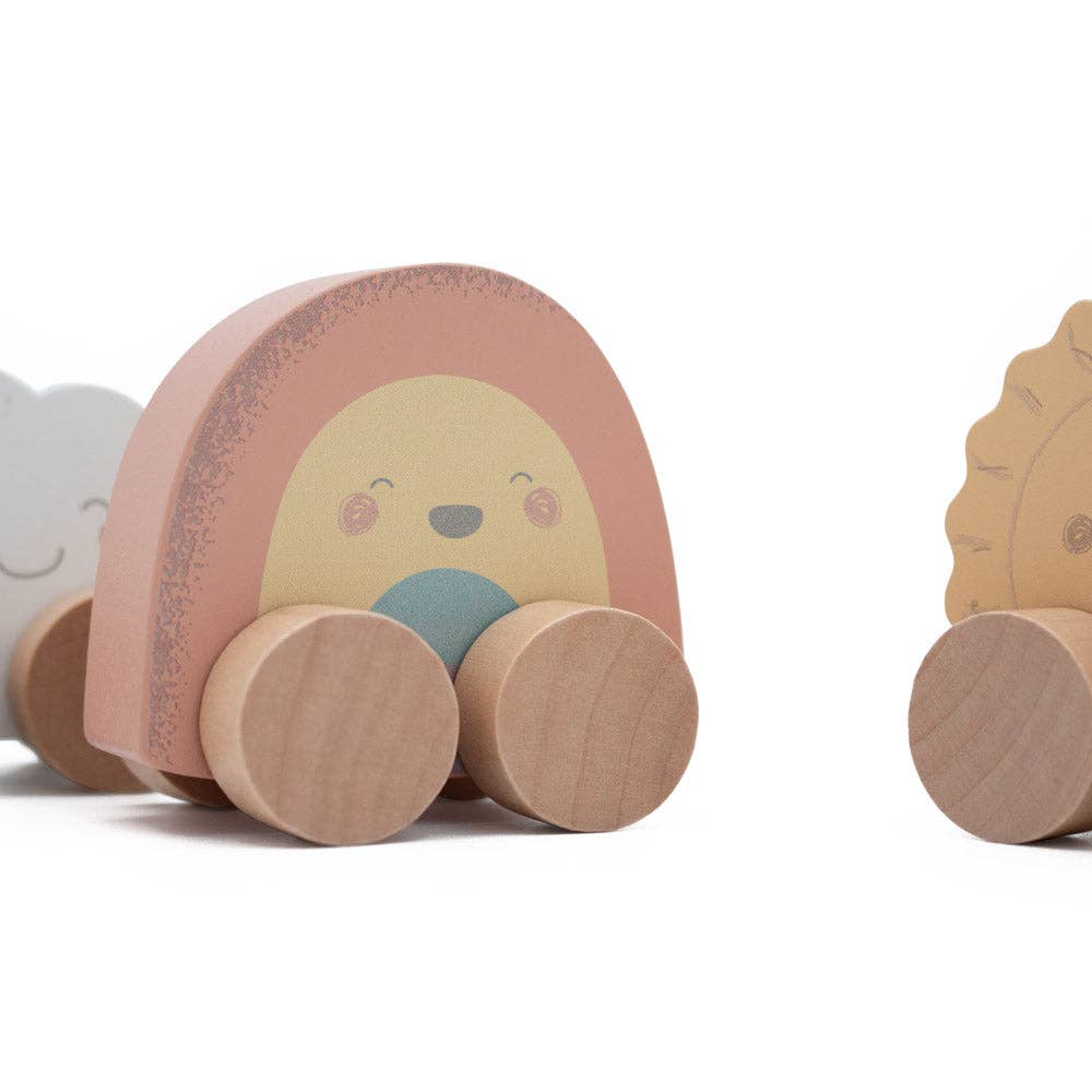 Wooden mini rainbow push along toy with a face on a white background