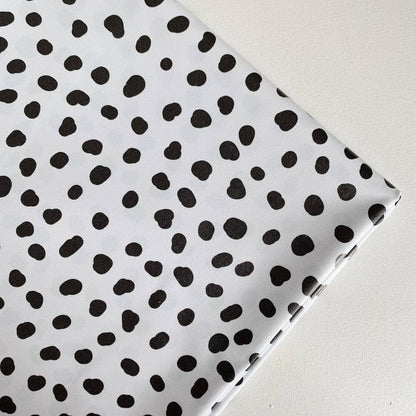 Splash mat with black polka dots on a white background