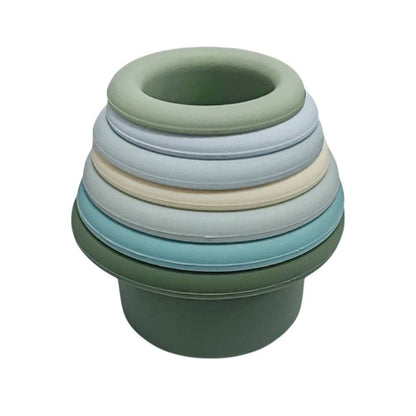 Stack of green and blue silicone stacking cups on a white background