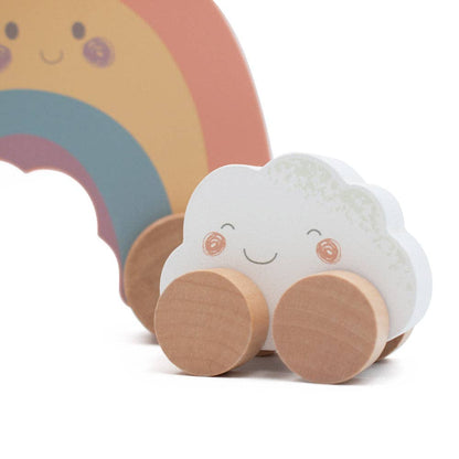 Toy cloud with wheels and a rainbow in the background
